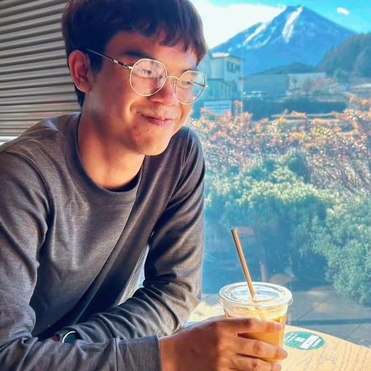 Palm at a cafe with Mt. Fuji in the background.